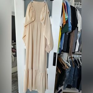 Crème color smock dress with off the shoulder long sleeves.